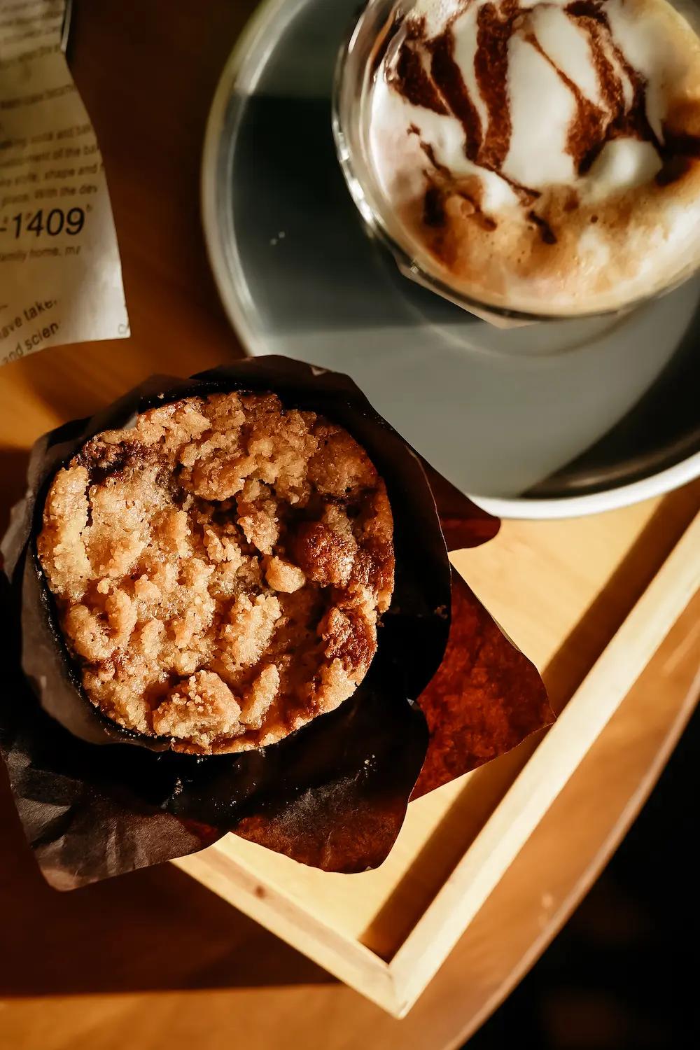 A coffee and cupcake shown from an aerial view.